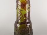 a brown vase with a green and yellow design on it