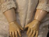 a close up of a doll wearing a white dress