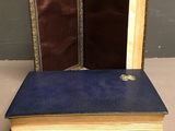 a blue book with two open pages sitting on top of a table