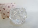 a glass object that is sitting next to a box