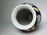 a black and white vase with a floral design on it