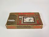 an old nintendo game console sitting on top of a white surface
