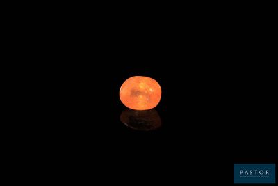une lune orange dans le ciel sombre, dont le reflet se dessine sur le sol