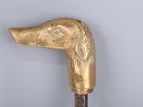 a gold colored cane with a bird head on it