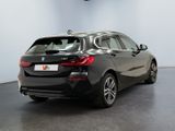 the back of a black bmw car in a showroom