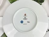 many plates with different designs on them on a table