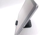 a tablet computer sitting on a stand on a white surface