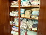 a cabinet with a lot of folded clothes in it