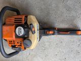a close up of a chainsaw on a concrete surface