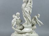 a statue of a woman and two children on a boat
