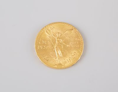 a close up of a gold coin on a white surface