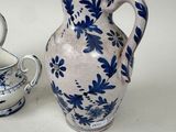 a blue and white vase next to a white and blue bowl