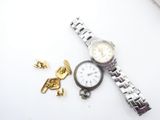 a watch that is laying on a table next to a gold cuff
