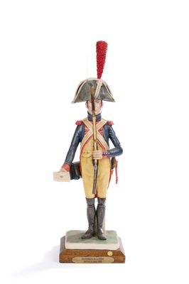 figurine of a soldier in uniform with a red feather on his head