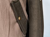 the back of a brown jacket with a black jacket on it