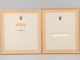 two framed photographs of a clock and a key hanging on a wall