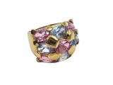 a close up of a gold ring with pink and blue stones
