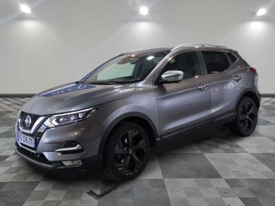 a grey nissan suv parked on a checkered floor in a garage