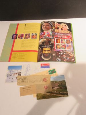 une table sur laquelle se trouvent plusieurs cartes postales et un livre