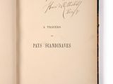 an open book with handwriting on it sitting on a white surface