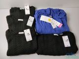 three pairs of black, blue, and grey sweaters with tags on them
