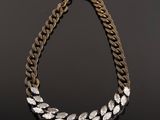 a gold and diamond necklace, by person