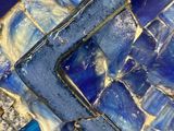 a close up of a blue and white mosaic tile