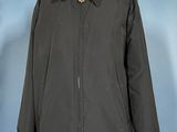 a black jacket on a mannequin stand against a blue background