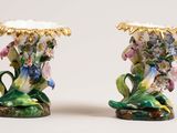two vases that are decorated with flowers on them
