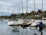 many boats that are docked in the water near the shore