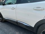 a white car parked on the side of the road