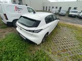 a white car that is parked next to a white van