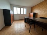 an empty room with a desk and chairs in it