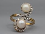 a close up of a pair of rings with pearls and diamonds