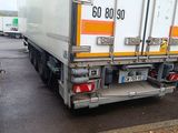 two semi trucks parked next to each other in a parking lot