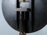 an image of a clock on a stand on a gray background