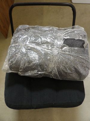 a black chair with a plastic bag on top of it