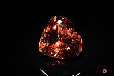 an orange diamond is shown on a black surface