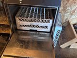 a black oven with a rack of dishes inside of it