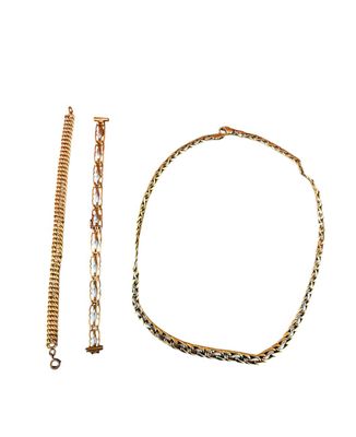 a close up of a bracelet and a chain on a white background