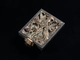an image of a silver box with flowers and leaves on it