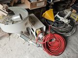 a machine that is sitting on the ground next to a bunch of tools