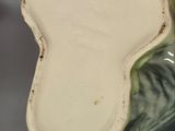 an image of a close up of a person holding a vase in their hand