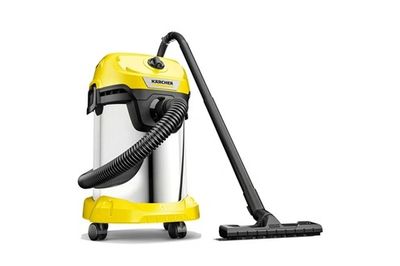 un aspirateur jaune muni d'un tuyau noir sur fond blanc