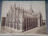 an old photo of a very large building in the middle of a city