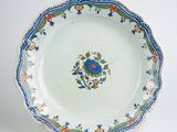 a blue and white plate with a flower design on it