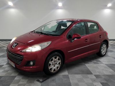 a red car is parked in a room with a checkered floor