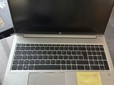 a laptop computer sitting on a table with a sticky note on it