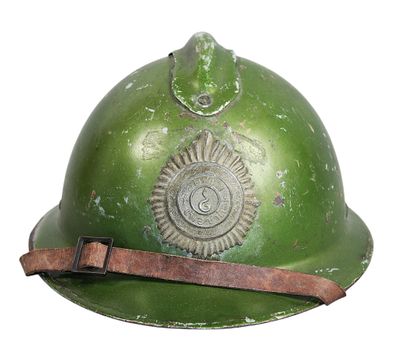 an old green fire helmet with a leather strap on a white background