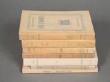 several books stacked on top of each other on a table